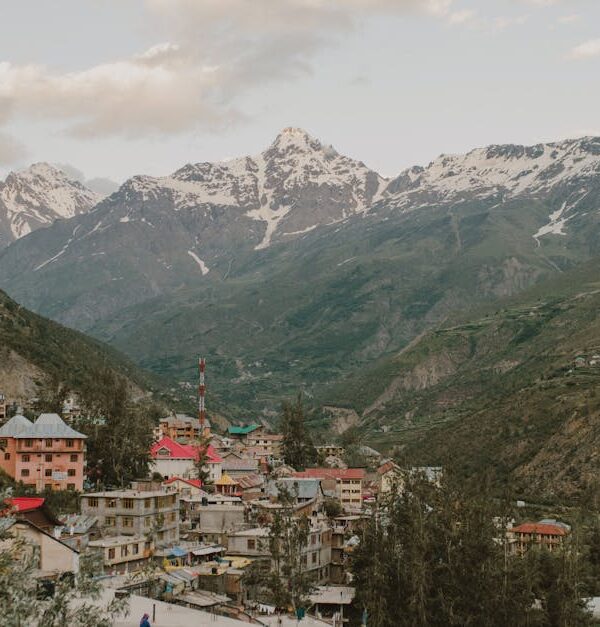 Picturesque village nestled in the Himalayan mountains of Manali, India, during a calm day.